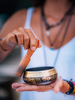 Young woman with Tibetan Singing Bowl Close up image of woman’s hands holding Tibetan Singing Bowl Outdoors